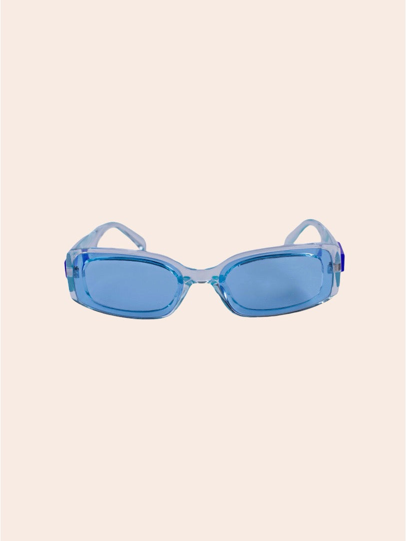 Blue sunglasses on a light pink background
