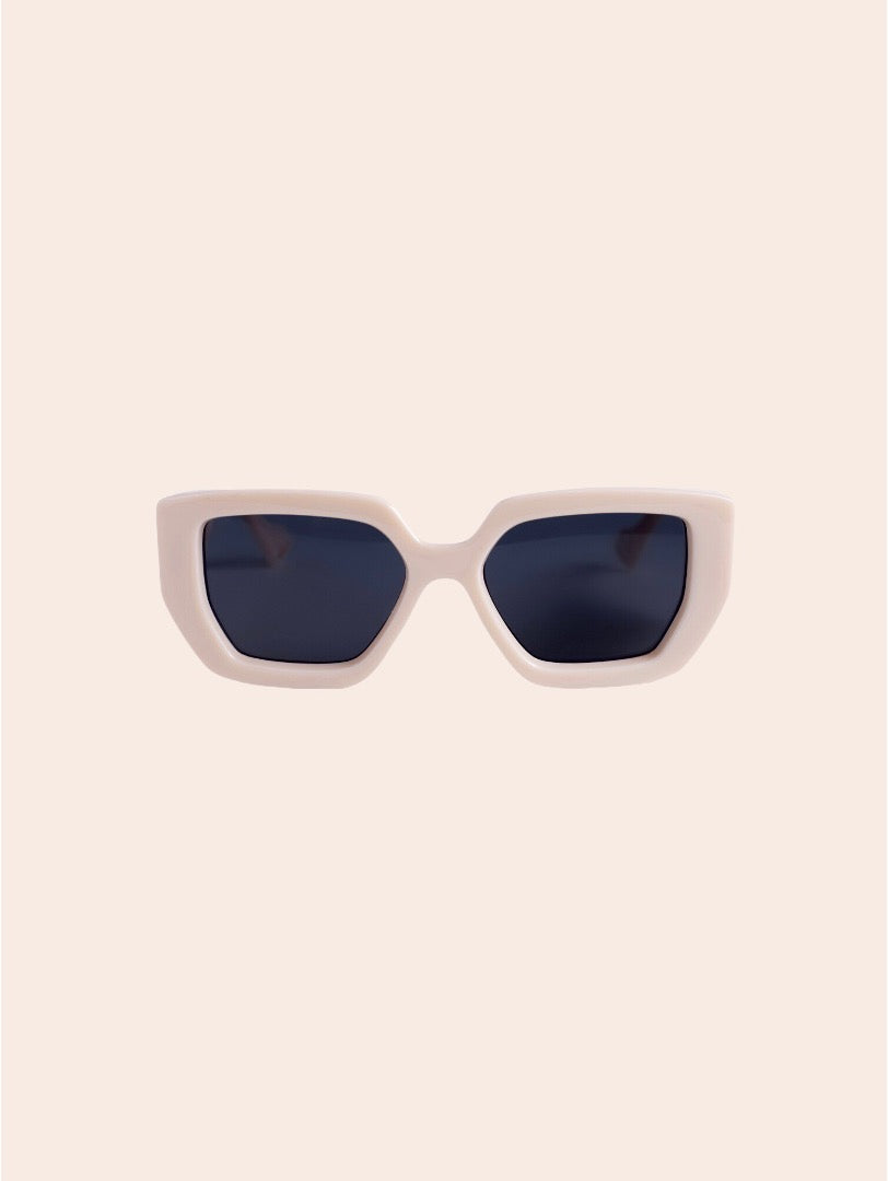 White sunglasses with dark lenses on a light pink background