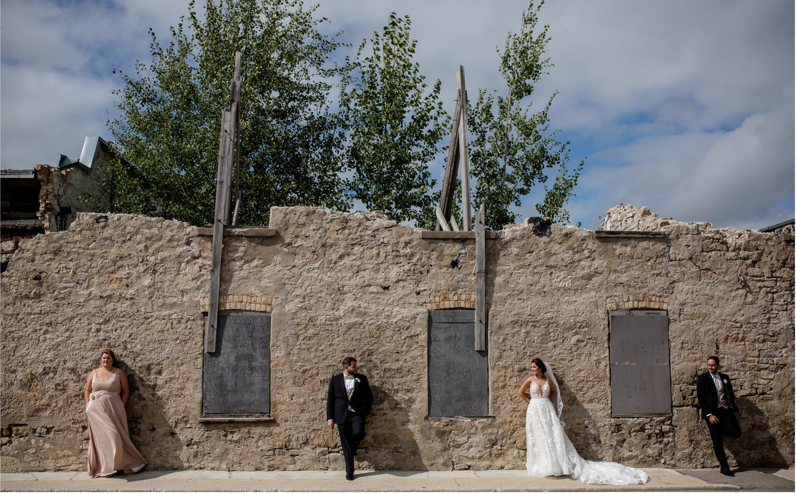 Rustic stone building with wooden posts, wedding venue architecture